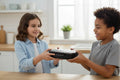 Girl handing lunch box to boy